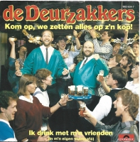 De Deurzakkers - Kom Op, We Zetten Alles Op Z'n Kop  (Single)